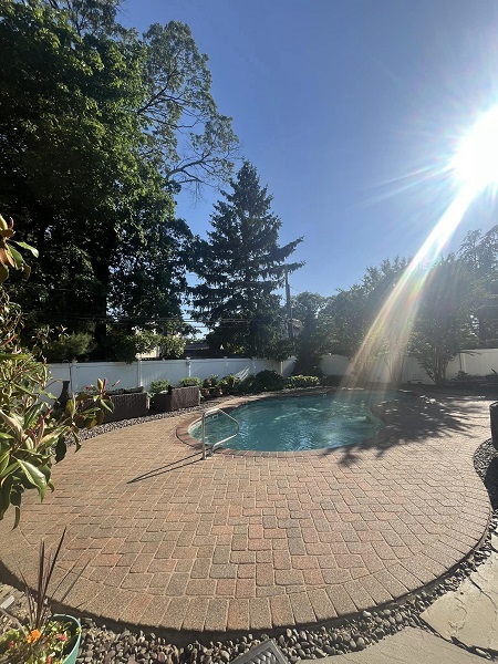 Backyard pool with clear blue water and surrounding deck