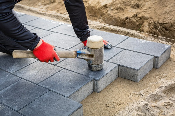 photo of man laying brick