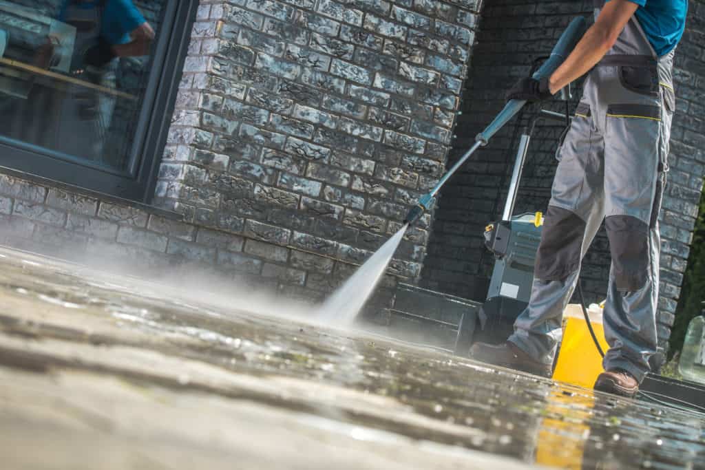 man pressure washing